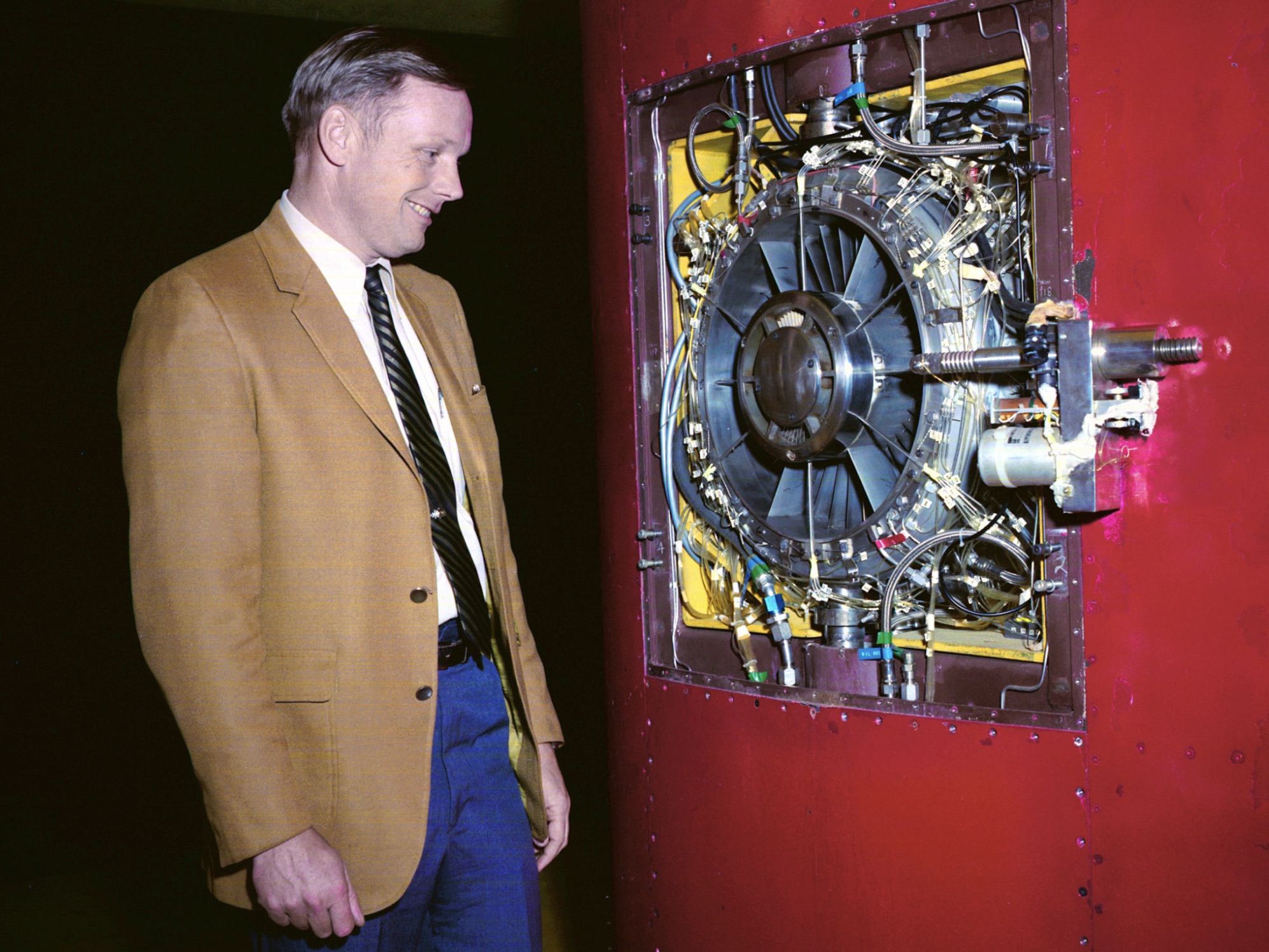 Astronaut Neil Armstrong examines a Vertical and Short Takeoff and Landing test setup 